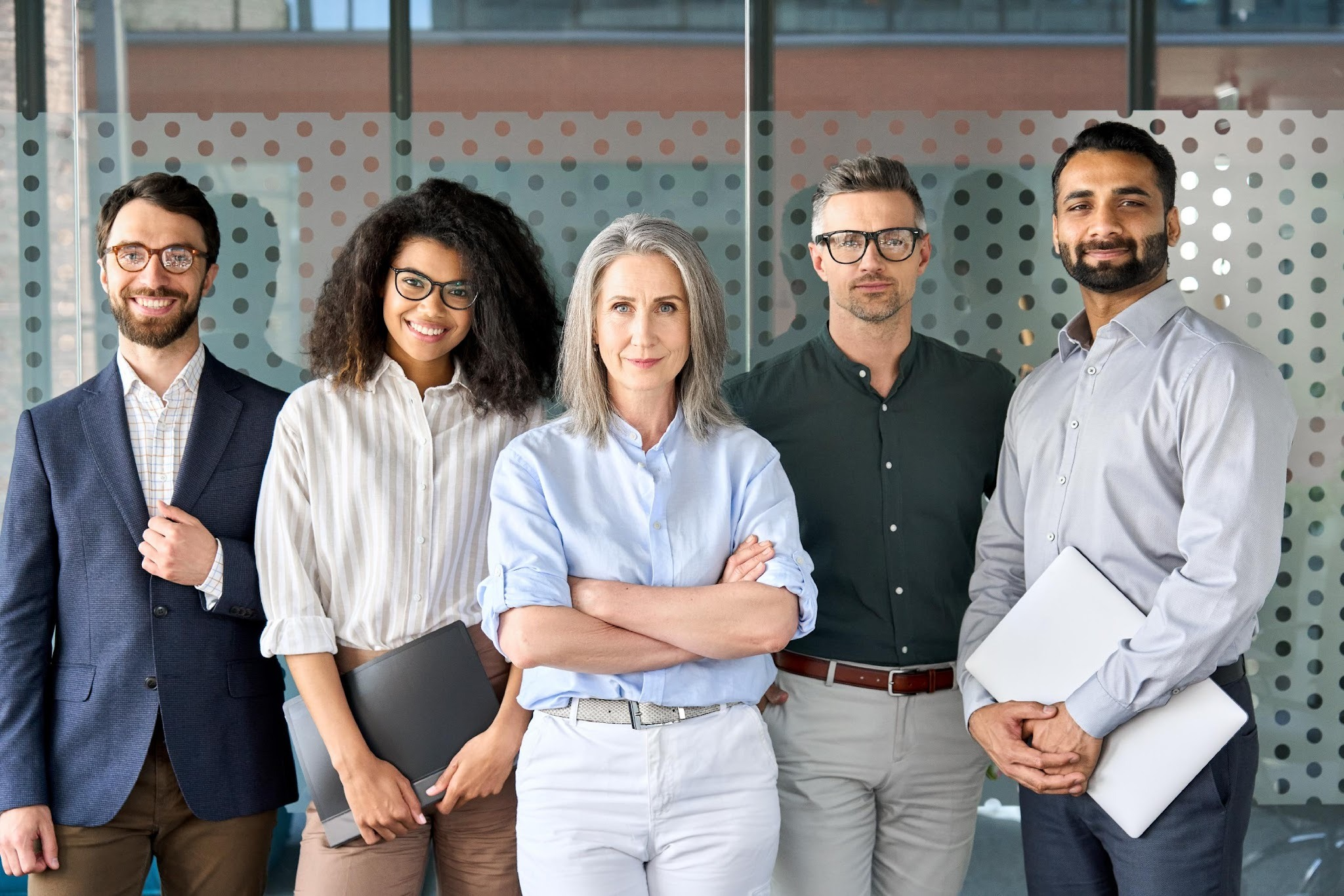 Diverse team of healthcare growth professionals standing confidently in a modern office